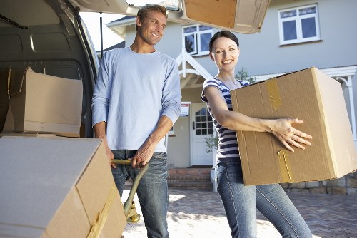 Experienced movers loading household items into a removal van